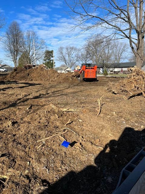 Bulldozer moving a pile of dirt in a field with blue object - Campbellsburg, IN | Twisted Electric LLC 