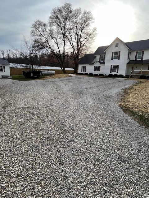 Large white house with a gravel driveway in front of it during the morning - Campbellsburg, IN | Twisted Electric LLC 