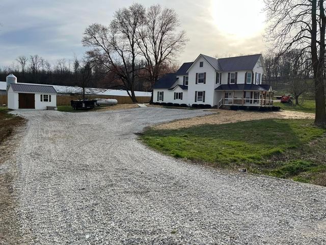 White house with a black roof and a gravel driveway in front of it - Campbellsburg, IN | Twisted Electric LLC 