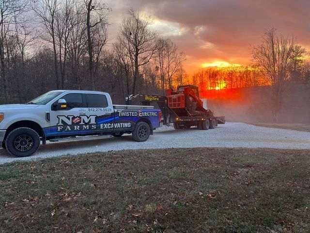 Tractor being towed by a truck on a gravel road - Campbellsburg, IN | Twisted Electric LLC 