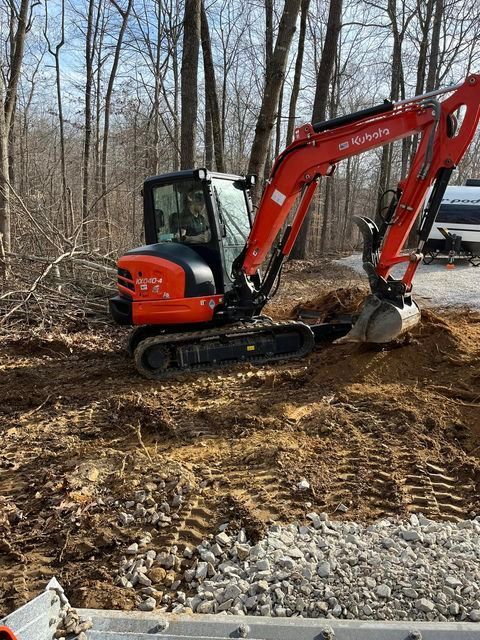 Red and black excavator digging a hole in the dirt in the woods - Campbellsburg, IN | Twisted Electric LLC 