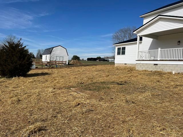 Large yard with a white house and a barn in the background - Campbellsburg, IN | Twisted Electric LLC 