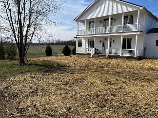 Large white house with a lot of hay in front of it - Campbellsburg, IN | Twisted Electric LLC 