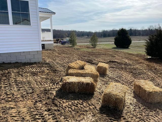 Bunch of hay bales are sitting in the dirt in front of a house - Campbellsburg, IN | Twisted Electric LLC 