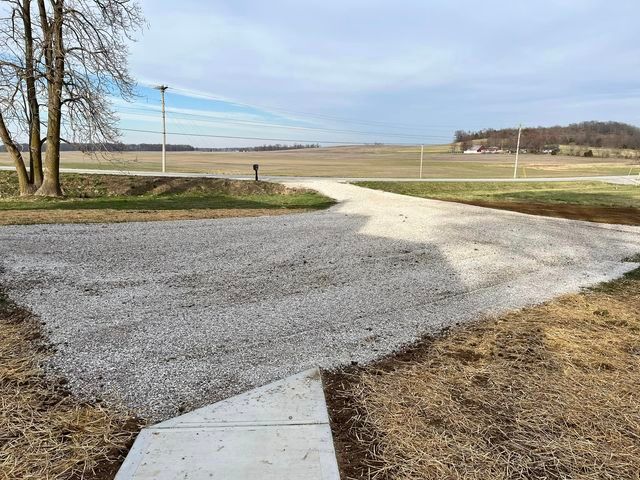 Gravel road going through a field with a mailbox on the side of it - Campbellsburg, IN | Twisted Electric LLC 
