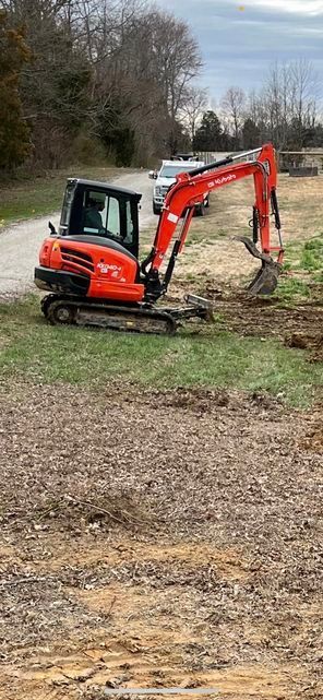 Petite red excavator sitting in the middle of a dirt field - Campbellsburg, IN | Twisted Electric LLC 
