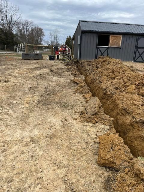 Large pile of dirt sitting in a field next to a barn - Campbellsburg, IN | Twisted Electric LLC 