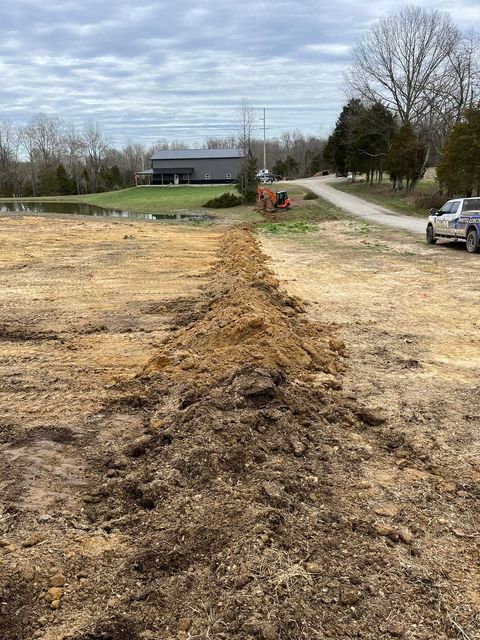 Large pile of dirt sitting on the side of a dirt road - Campbellsburg, IN | Twisted Electric LLC 