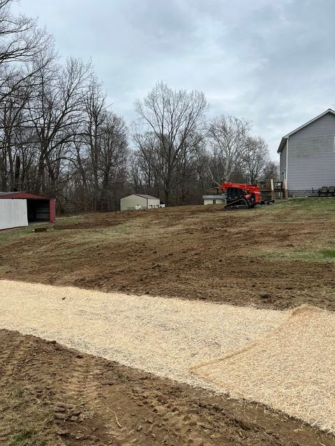 Large dirt field with a house in the background and cloudy sky - Campbellsburg, IN | Twisted Electric LLC 