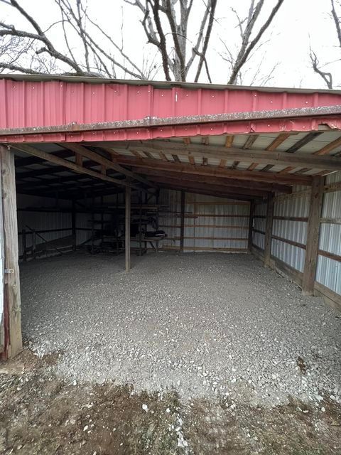 Empty barn with a red roof and a gravel floor - Campbellsburg, IN | Twisted Electric LLC 