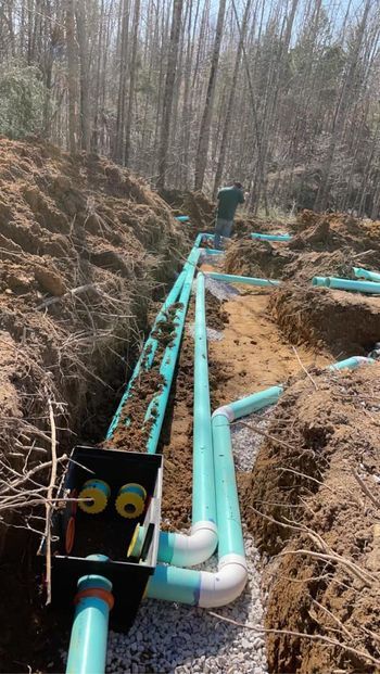 Man working on a drainage system in the woods - Campbellsburg, IN | Twisted Electric LLC 