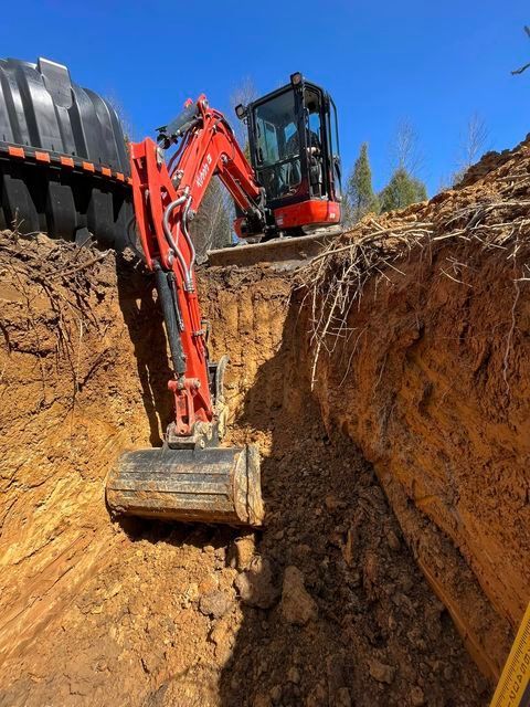 Red excavator digging a large hole in the dirt - Campbellsburg, IN | Twisted Electric LLC 