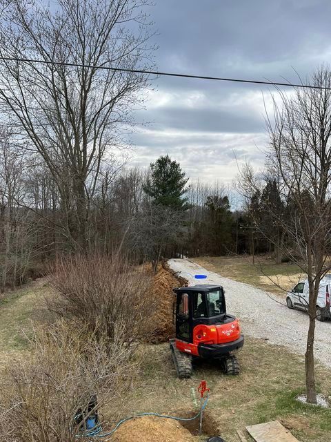 Small red and black excavator digging a hole in the ground - Campbellsburg, IN | Twisted Electric LLC 