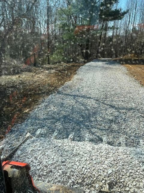 Tractor driving down a gravel road in the woods - Campbellsburg, IN | Twisted Electric LLC 