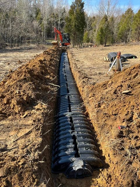 Hot weather with large septic tank being installed in a dirt field - Campbellsburg, IN | Twisted Electric LLC 
