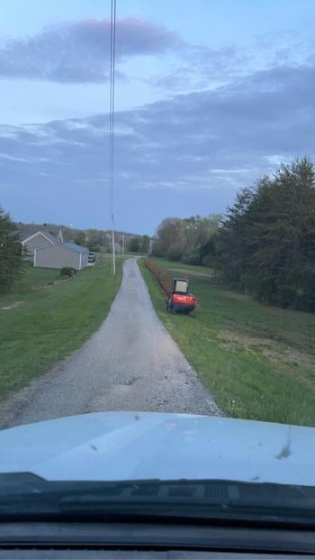 Red tractor parked on the side of a dirt road - Campbellsburg, IN | Twisted Electric LLC 