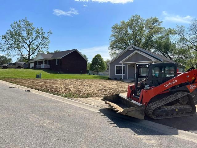 Bulldozer sitting on the side of the road in front of a house - Campbellsburg, IN | Twisted Electric LLC 