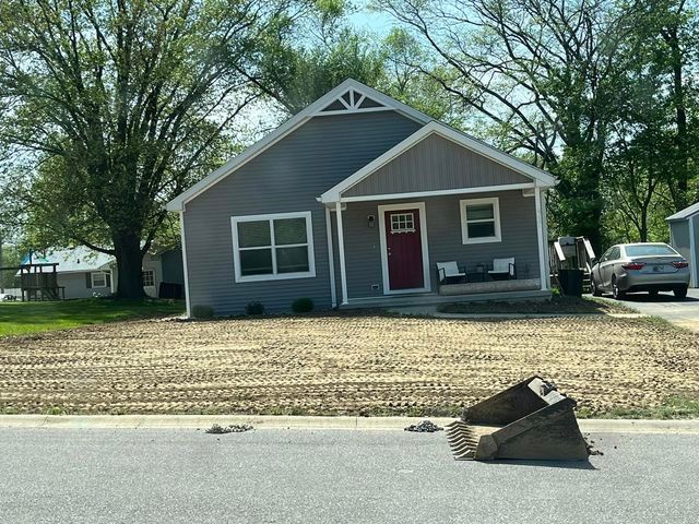 House with a red door and a bucket in front of it - Campbellsburg, IN | Twisted Electric LLC 