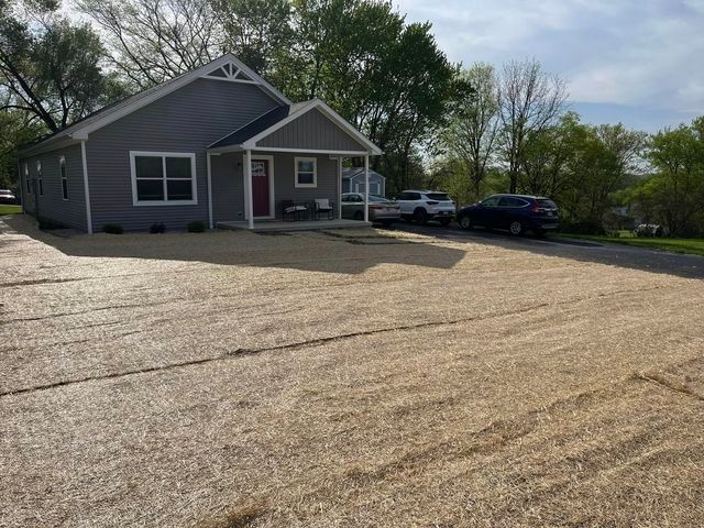 House with cars parked in front of it and a gravel driveway - Campbellsburg, IN | Twisted Electric LLC 