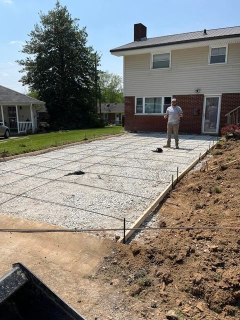 Man standing on a concrete driveway in front of a house with tree - Campbellsburg, IN | Twisted Electric LLC 