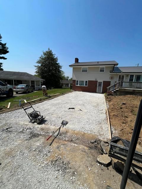 Man working on a gravel driveway in front of a house - Campbellsburg, IN | Twisted Electric LLC 
