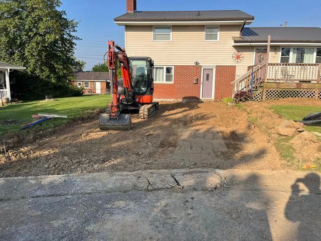 Small excavator sitting in front of a house - Campbellsburg, IN | Twisted Electric LLC 