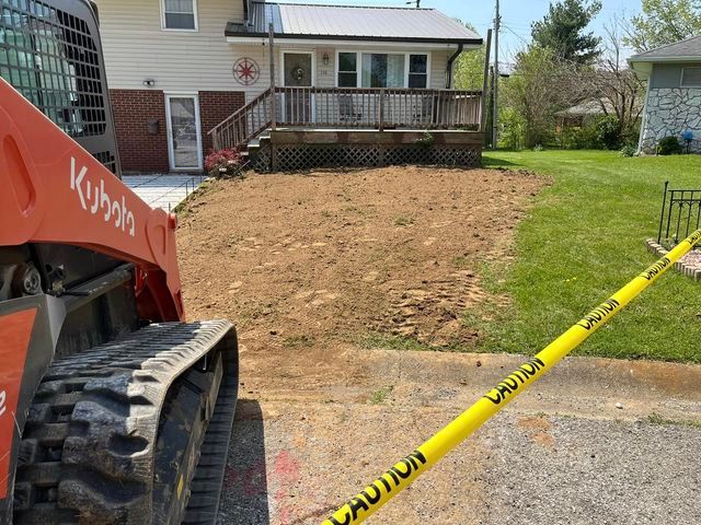 Kubota skid steer parked in front of a house with caution - Campbellsburg, IN | Twisted Electric LLC 