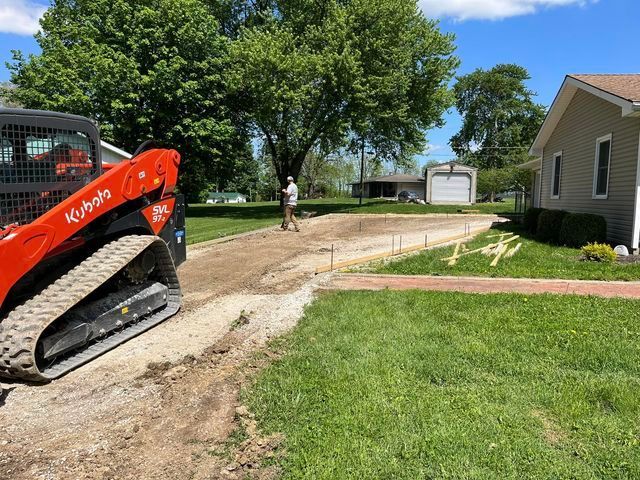 Man walking down a dirt road next to a kubota skid steer - Campbellsburg, IN | Twisted Electric LLC 