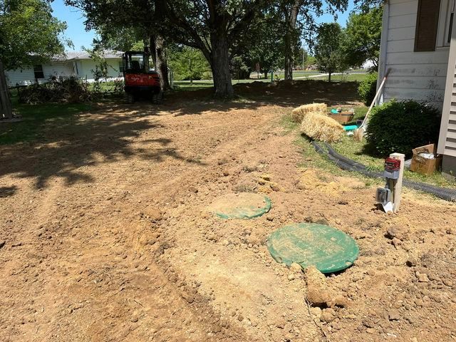 Round septic tank being installed in the dirt in front of a house - Campbellsburg, IN | Twisted Electric LLC 