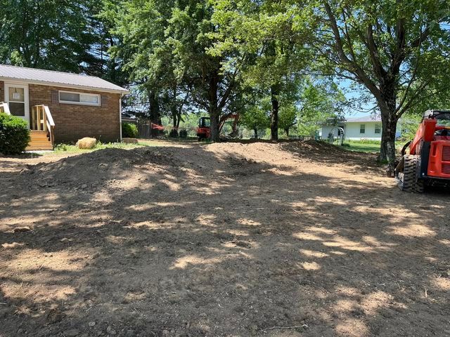 Large pile of dirt in front of a house with multiple trees - Campbellsburg, IN | Twisted Electric LLC 
