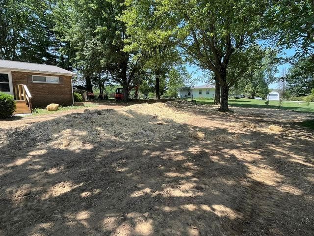 Large pile of dirt in front of a house with tree shadow - Campbellsburg, IN | Twisted Electric LLC 