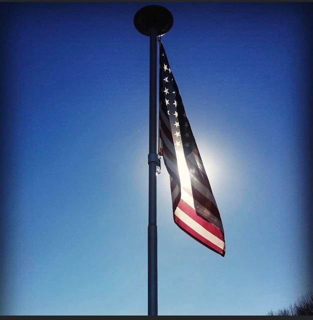 American flag on a pole with the sun shining - Campbellsburg, IN | Twisted Electric LLC 