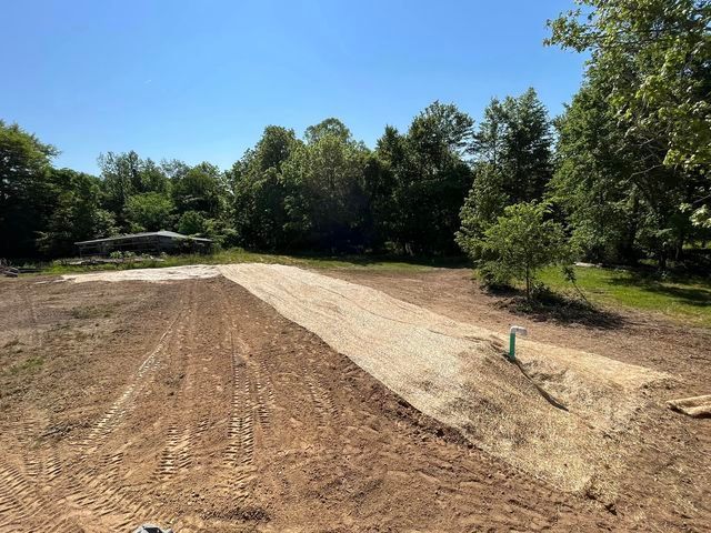 Dirt road being built in a field with trees in the background - Campbellsburg, IN | Twisted Electric LLC 
