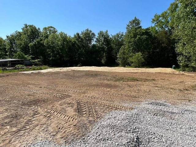 Large dirt field with gravel and trees in the background - Campbellsburg, IN | Twisted Electric LLC 