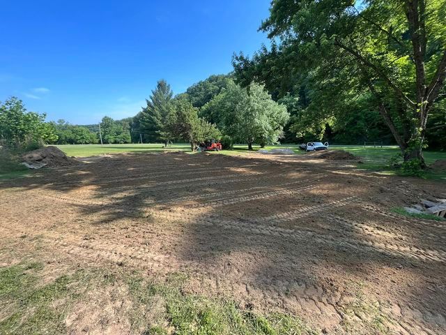 Large dirt field with a tractor and a truck in it - Campbellsburg, IN | Twisted Electric LLC 