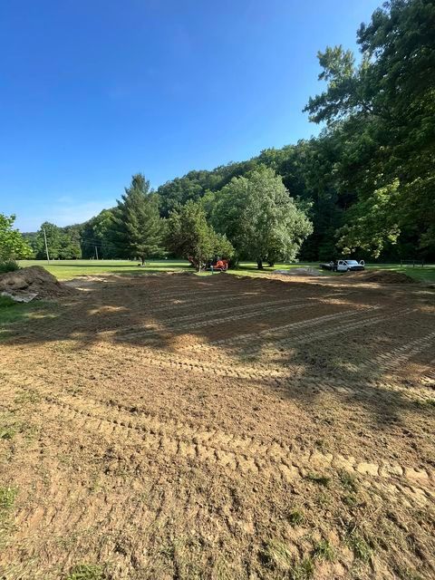 Large dirt field with a tractor in the middle of it - Campbellsburg, IN | Twisted Electric LLC 