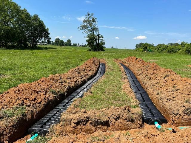 Two Septic system being installed in a field  with trees - Campbellsburg, IN | Twisted Electric LLC 
