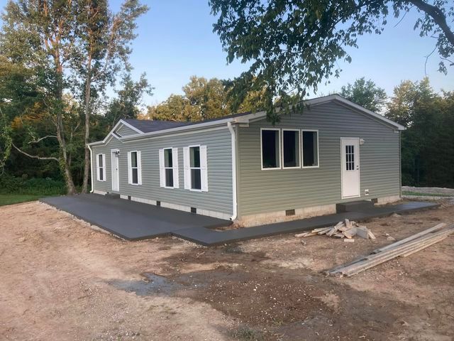 Mobile home with a concrete driveway in front of it - Campbellsburg, IN | Twisted Electric LLC 