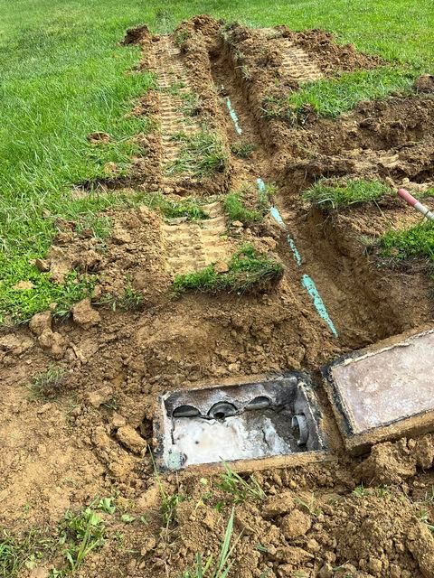 Septic tank being installed in a yard with dug up hole - Campbellsburg, IN | Twisted Electric LLC 