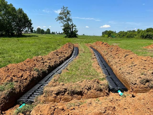 Long drainage system being installed in a field - Campbellsburg, IN | Twisted Electric LLC 