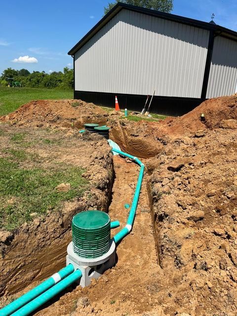 Septic system being installed in the dirt in front of a grey building - Campbellsburg, IN | Twisted Electric LLC 