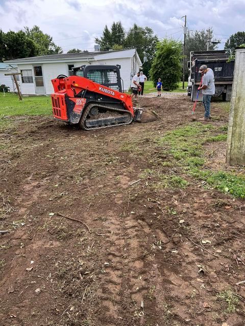 Group of people working on a dirt field in front of a house - Campbellsburg, IN | Twisted Electric LLC 