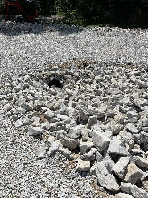 Pile of rocks sitting on top of a gravel road next to a pipe - Campbellsburg, IN | Twisted Electric LLC 