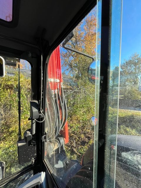 Inside of a construction vehicle with a red crane in the background - Campbellsburg, IN | Twisted Electric LLC 