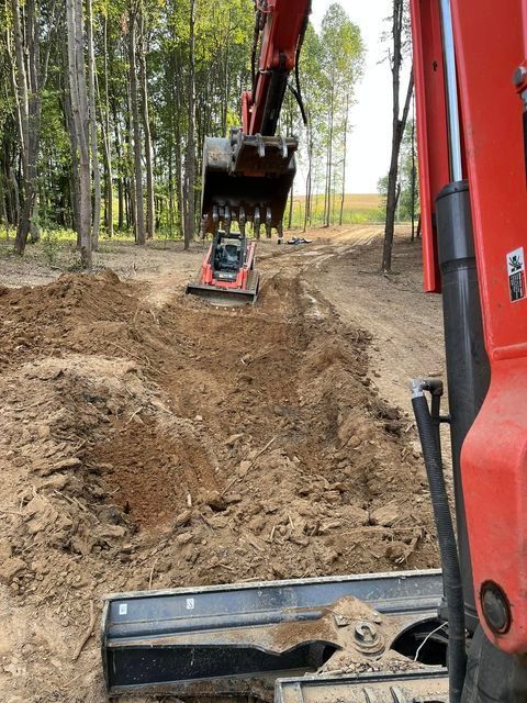 Red excavator digging a hole in the dirt - Campbellsburg, IN | Twisted Electric LLC 