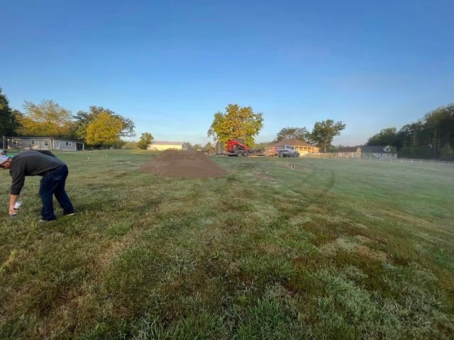 Man is standing in the middle of a lush green field - Campbellsburg, IN | Twisted Electric LLC 