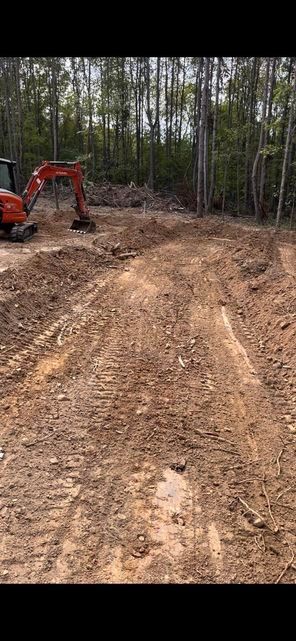 An excavator digging a hole in the dirt in the middle of a forest - Campbellsburg, IN | Twisted Electric LLC 