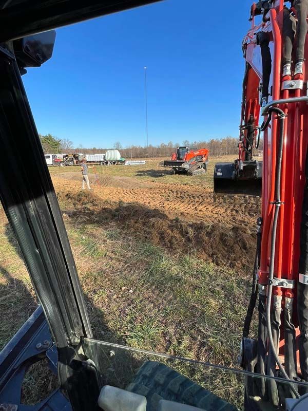 Red Excavator Is Digging A Hole — Campbellsburg, IN — Twisted Electric LLC