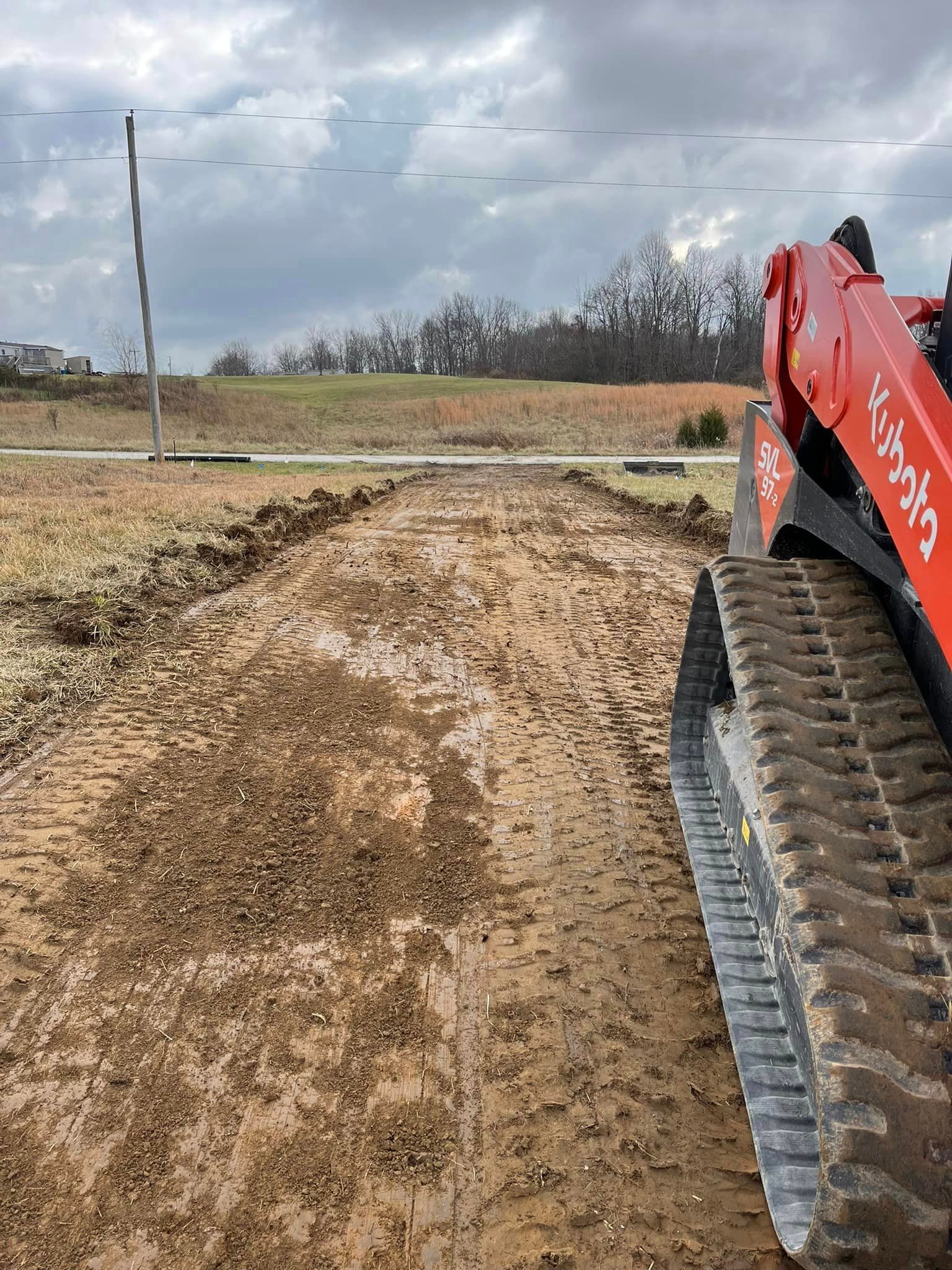 Red Tractor Driving On A Dirt Road — Campbellsburg, IN — Twisted Electric LLC