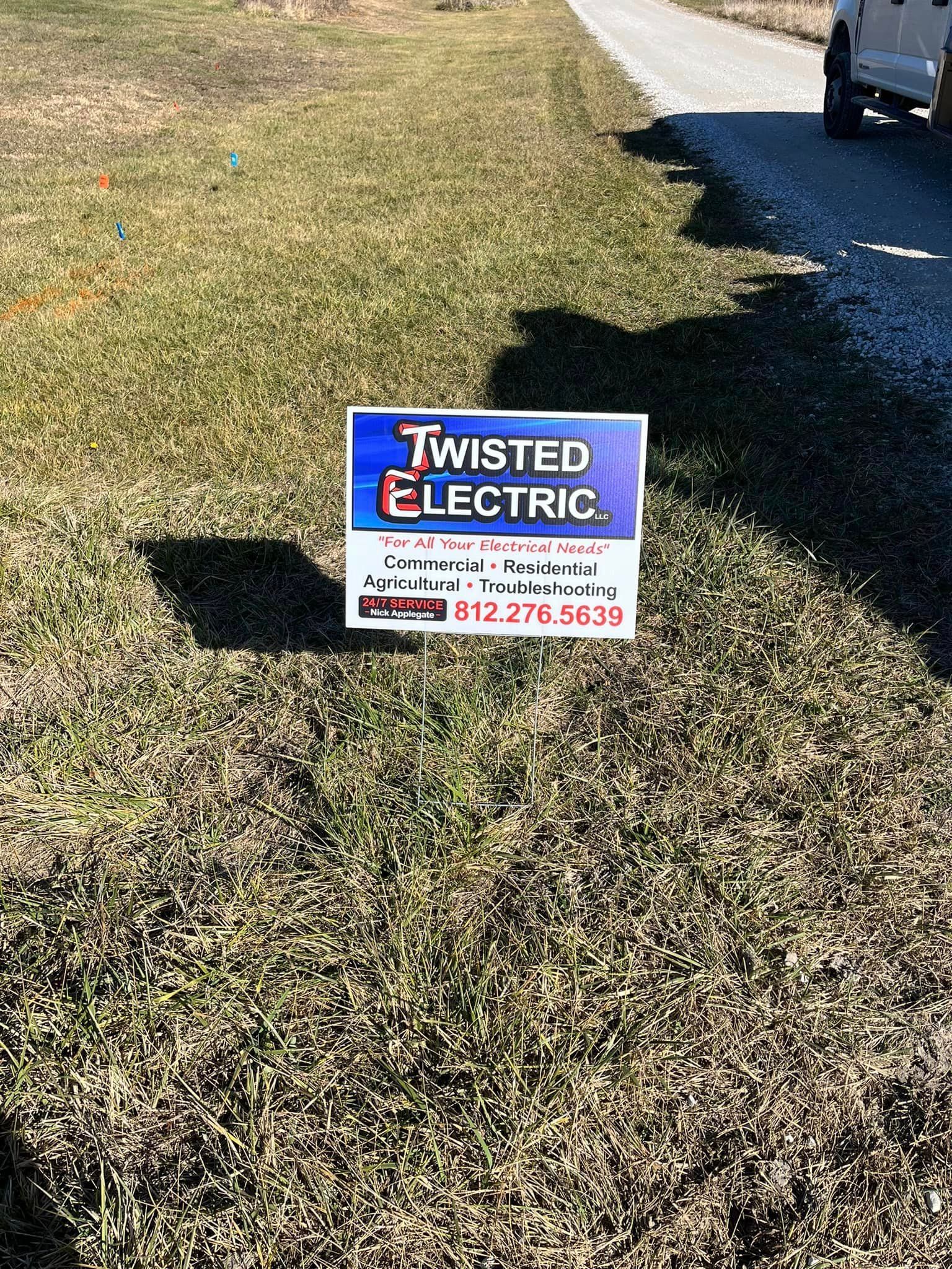 Twisted Electric Sign Lying On The Grass — Campbellsburg, IN — Twisted Electric LLC